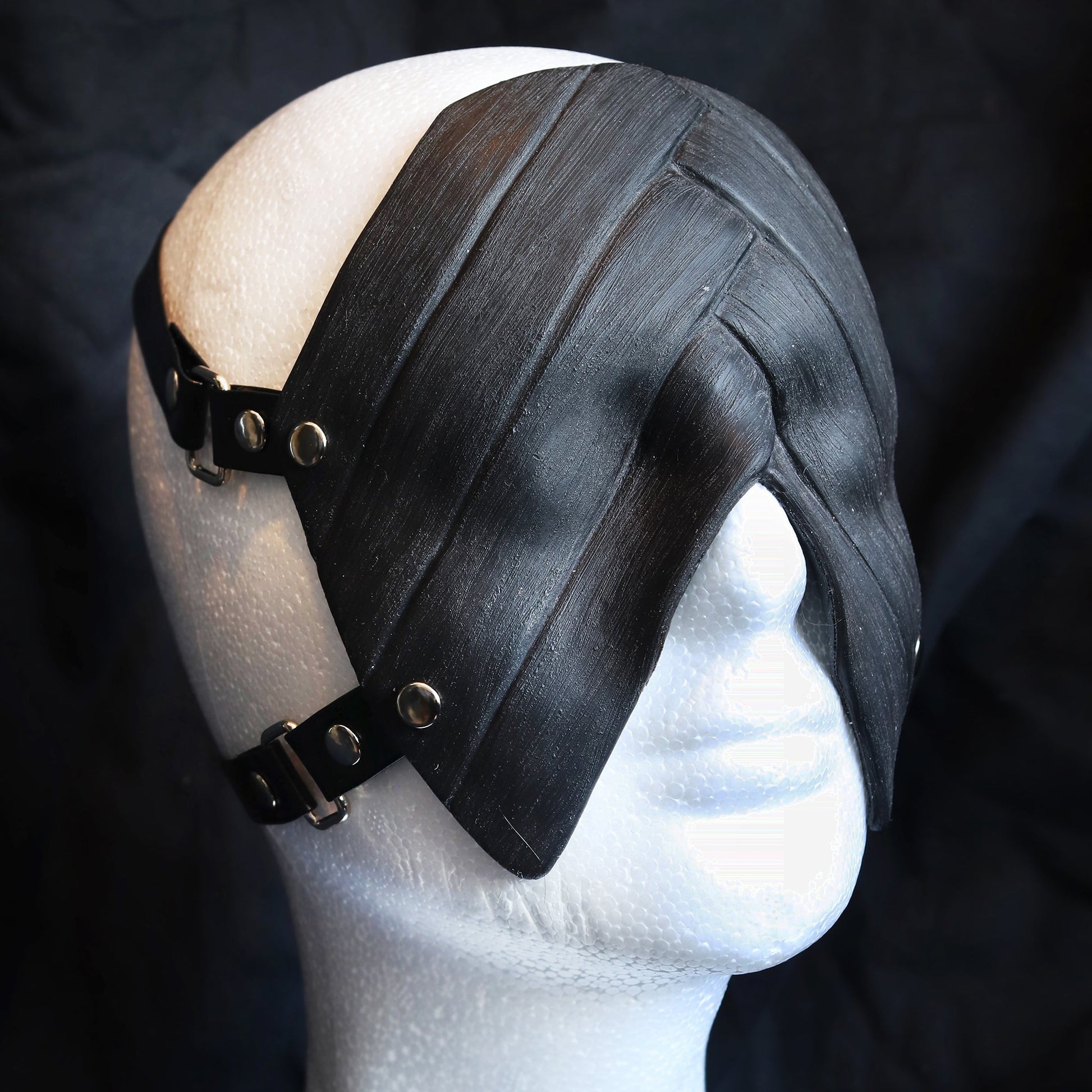 Black silicone blindfold on a white mannequin