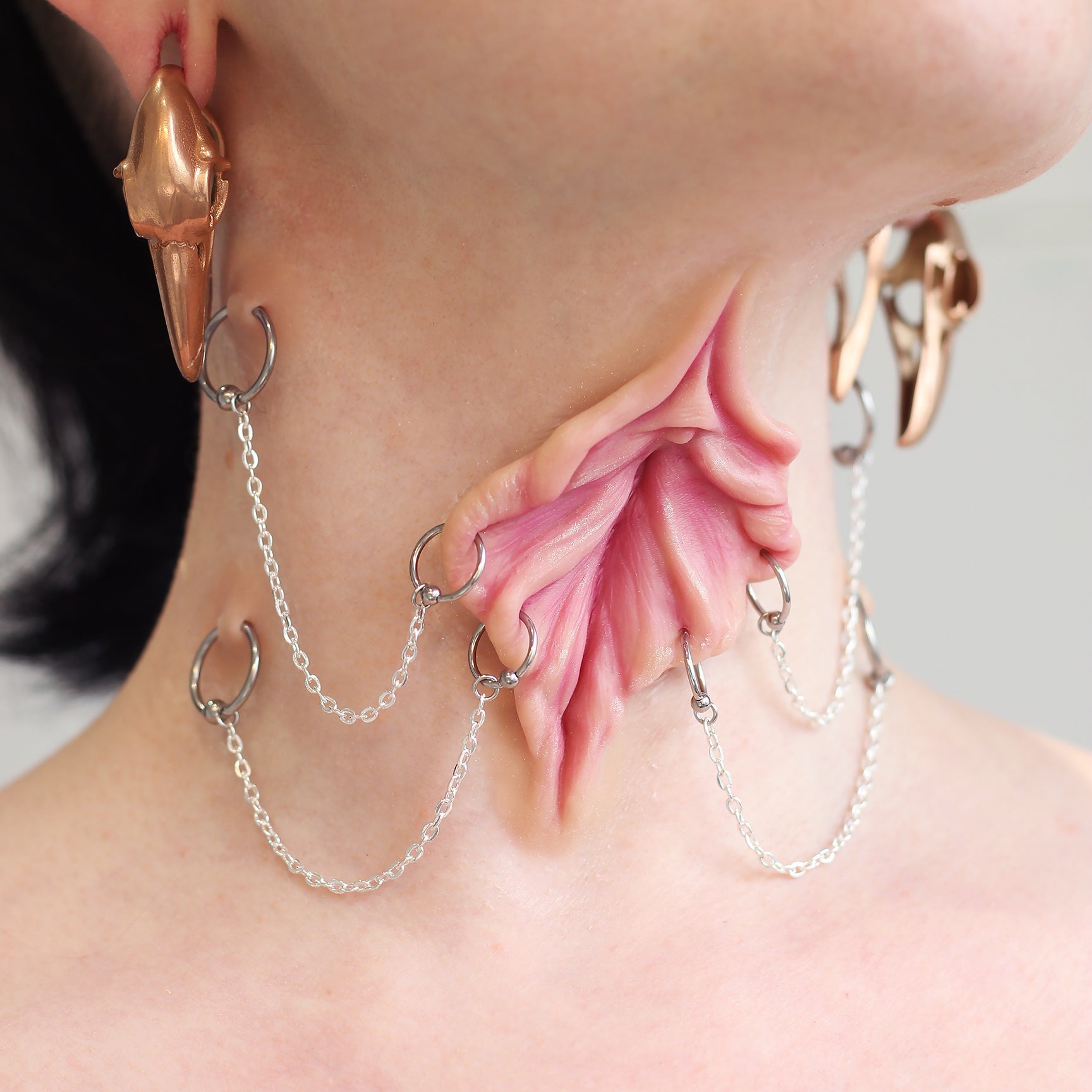 Woman's neck with a flower choker prosthetic