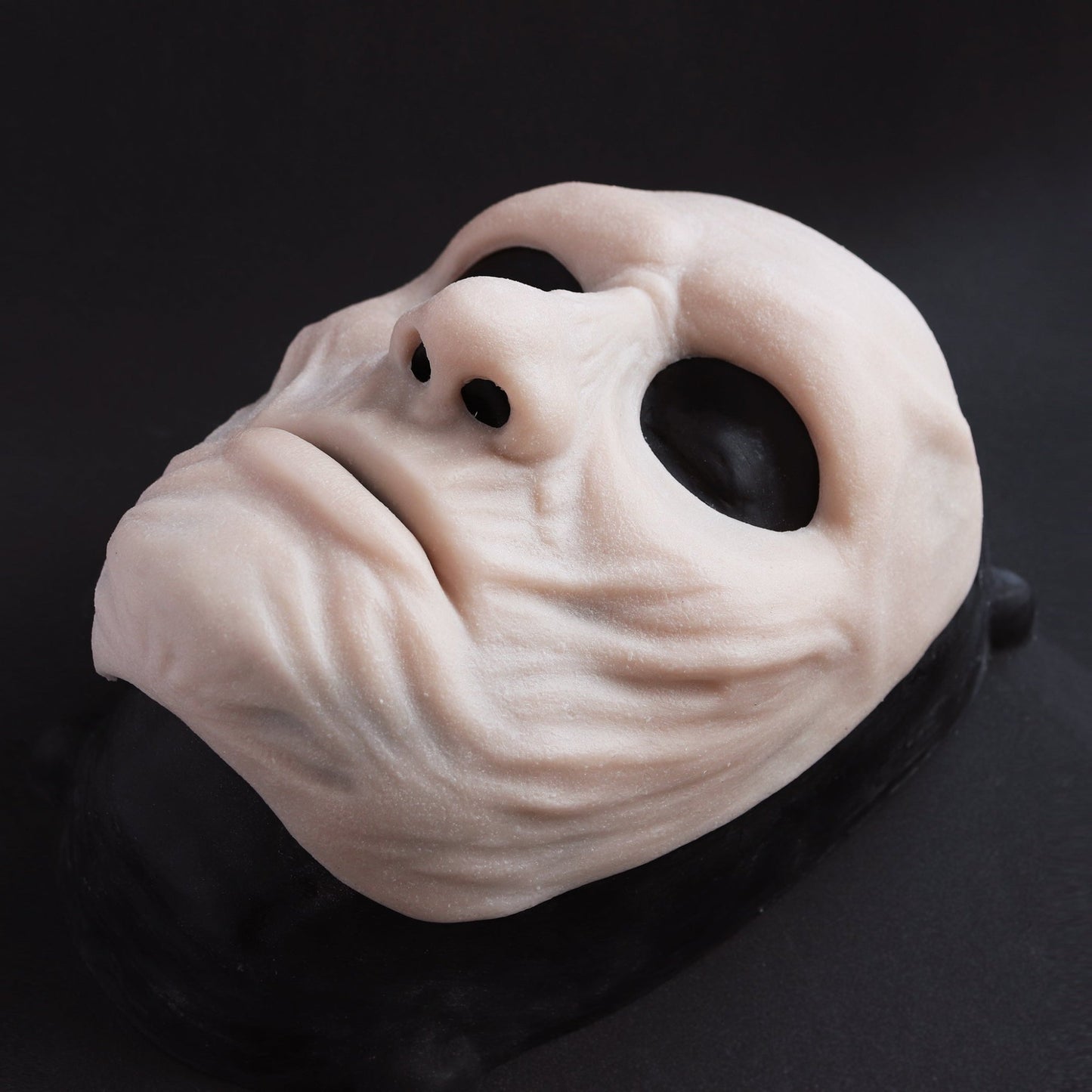 Ghoul Mask - Silicone makeup prosthetic in vanilla shade on a black surface