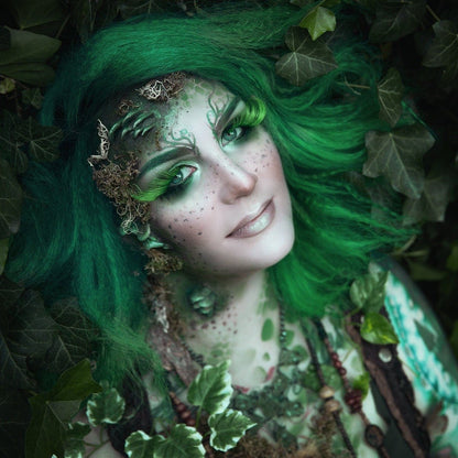 Woman with green hair wearing fungi prosthetics on her face