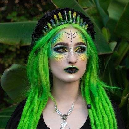Woman with green hair wearing mutant facial markings
