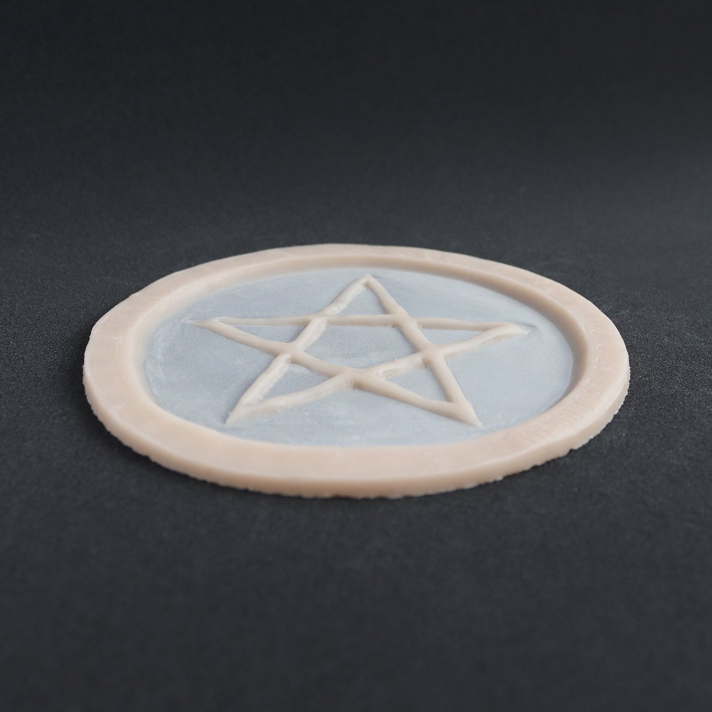 Pentagram Scarification - Silicone makeup prosthetic in vanilla shade on a black surface
