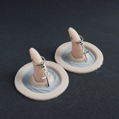Pierced Horns (Pair) - Silicone makeup prosthetic in vanilla shade on a black surface