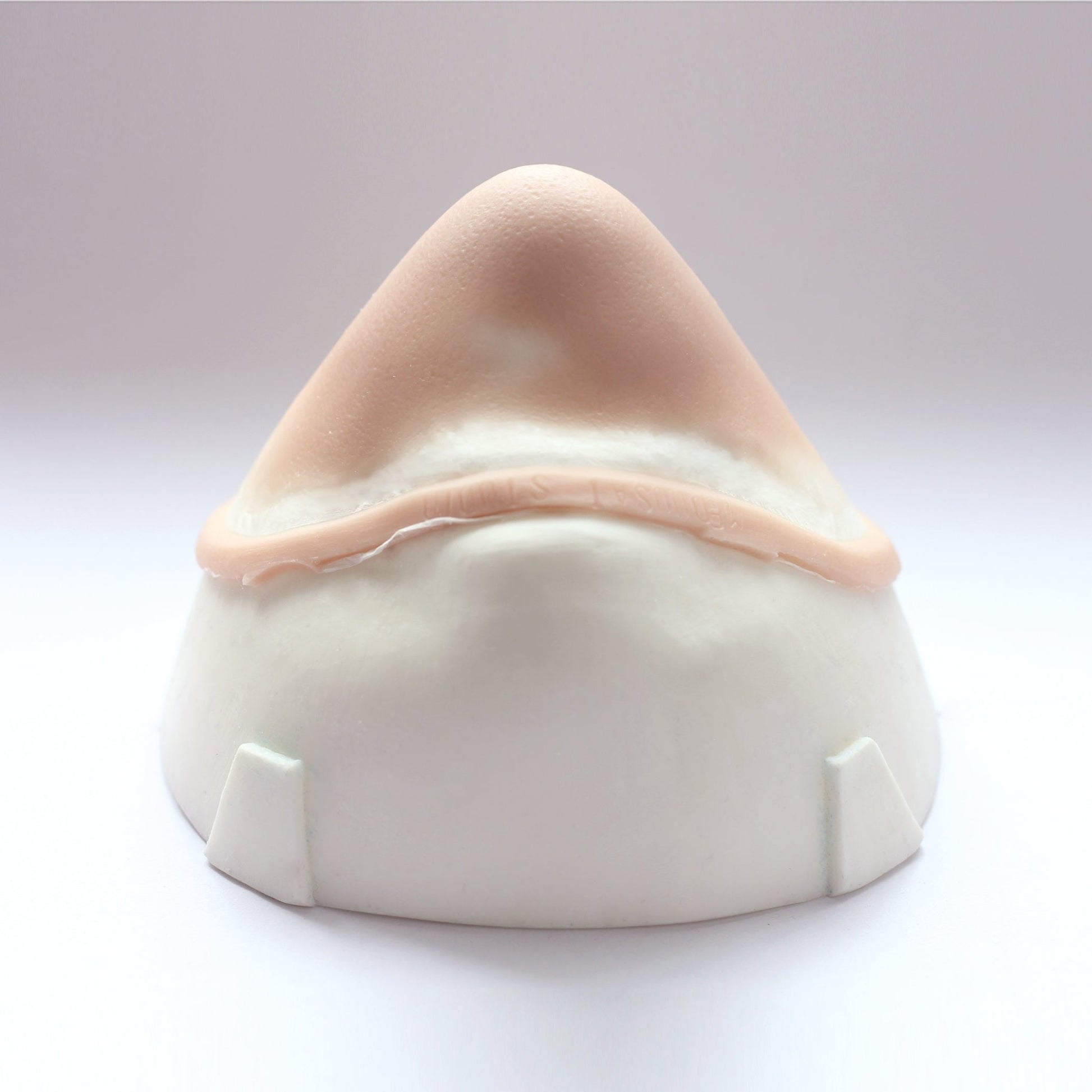 Pointy Chin - Silicone makeup prosthetic in vanilla shade on a white surface