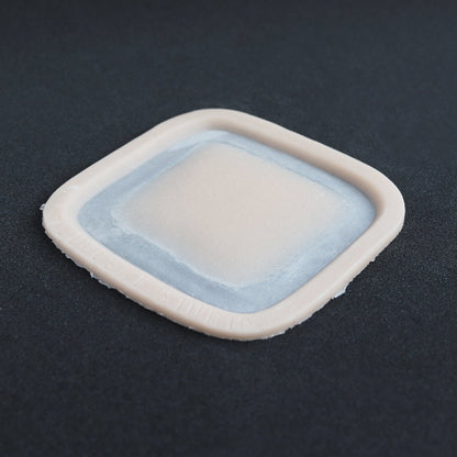 Mini Silicone Patch - Silicone makeup prosthetic in vanilla shade on a black surface