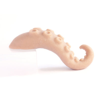Tentacle Tongue - Silicone makeup prop in vanilla shade on a white surface